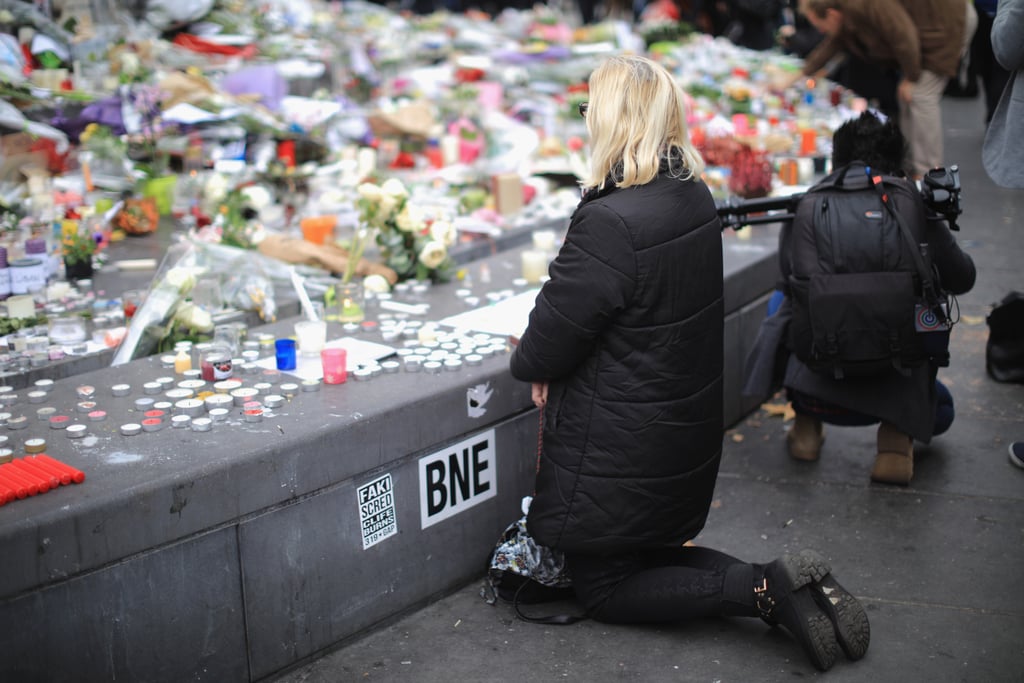 A woman knelt down during France's minute of silence.