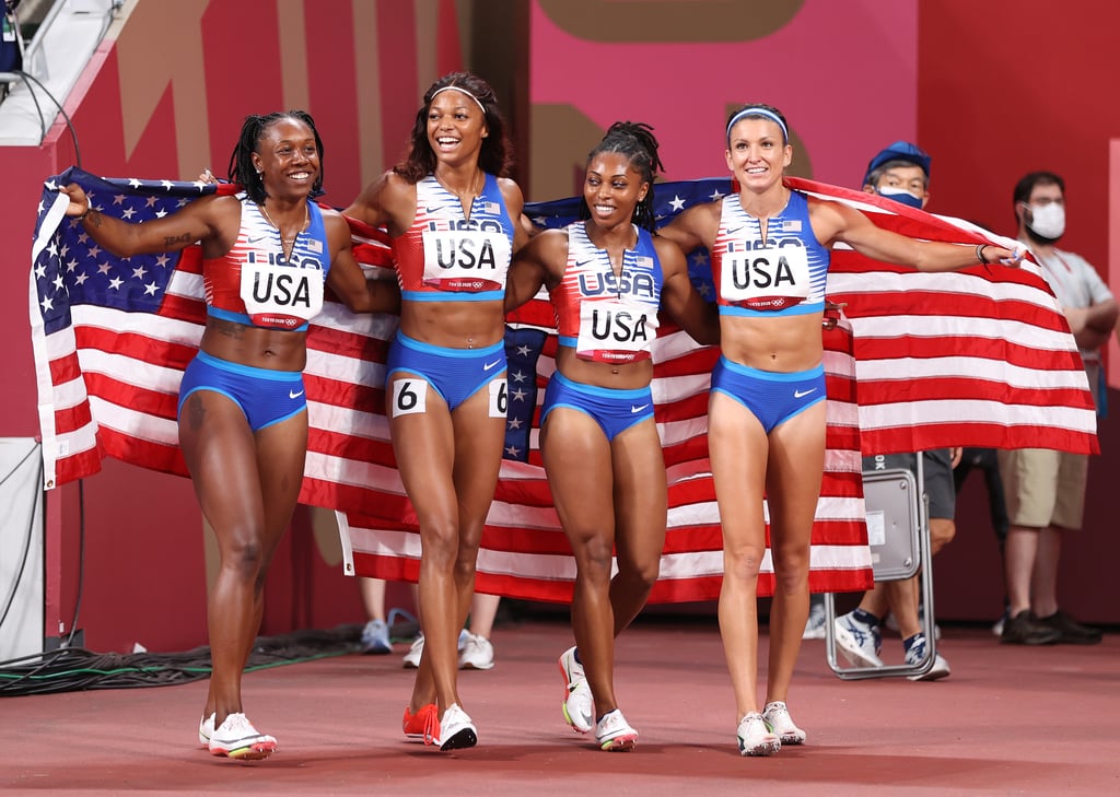 Teahna Daniels, Gabby Thomas, Javianne Oliver, and Jenna Prandini of Team USA celebrate winning silver in the women's 4x100m relay final at the 2021 Olympics.