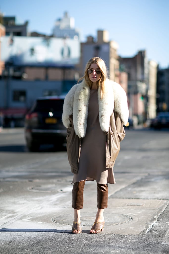 With a Long Neutral-Colored Shirt, a Furry Jacket, and Neutral Slip-On Shoes