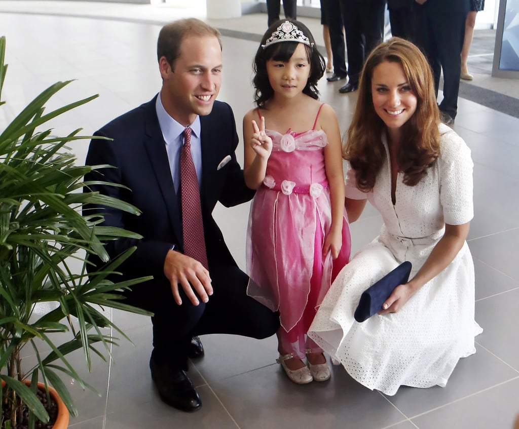Prince William and Kate posed with a 4-year-old dressed as a princess as they toured a Rolls-Royce factory in Singapore. Prince William and Kate posed with a 4-year-old dressed as a princess as they toured a Rolls-Royce factory in Singapore.