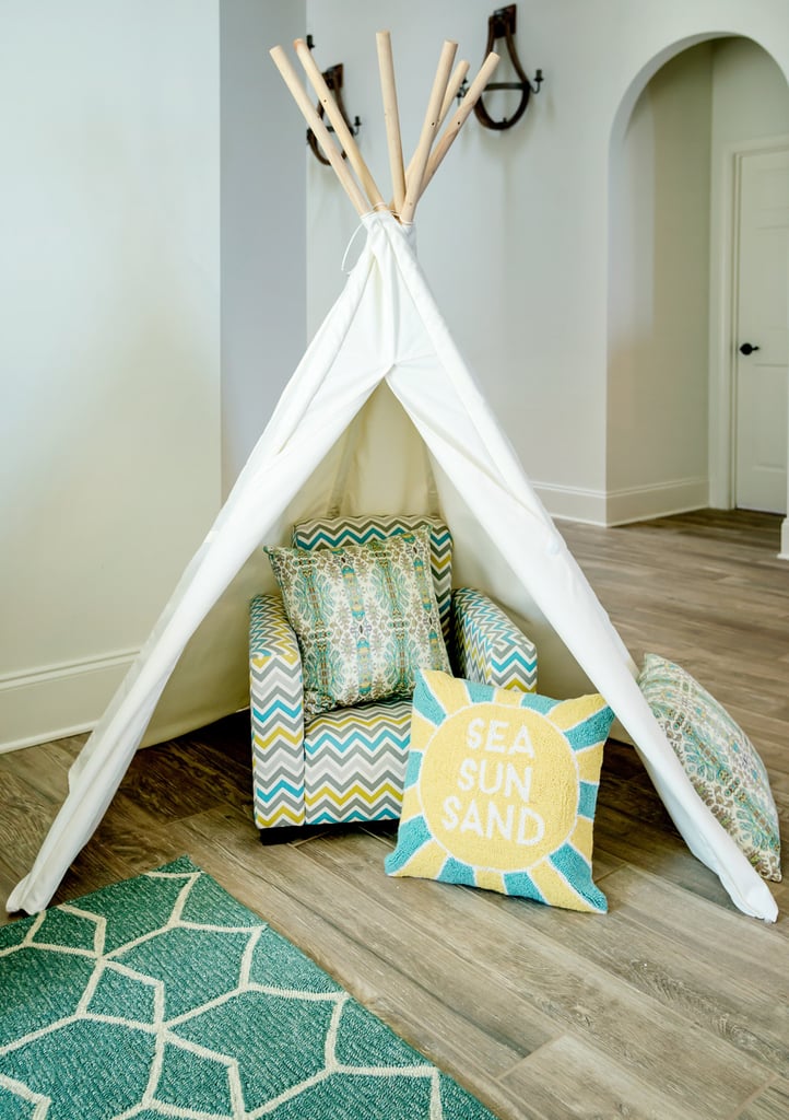 A playful tent and kid-size armchair make the living room feel anything but stuffy.