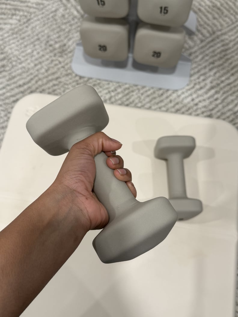Woman holding a WeGym dumbbell.