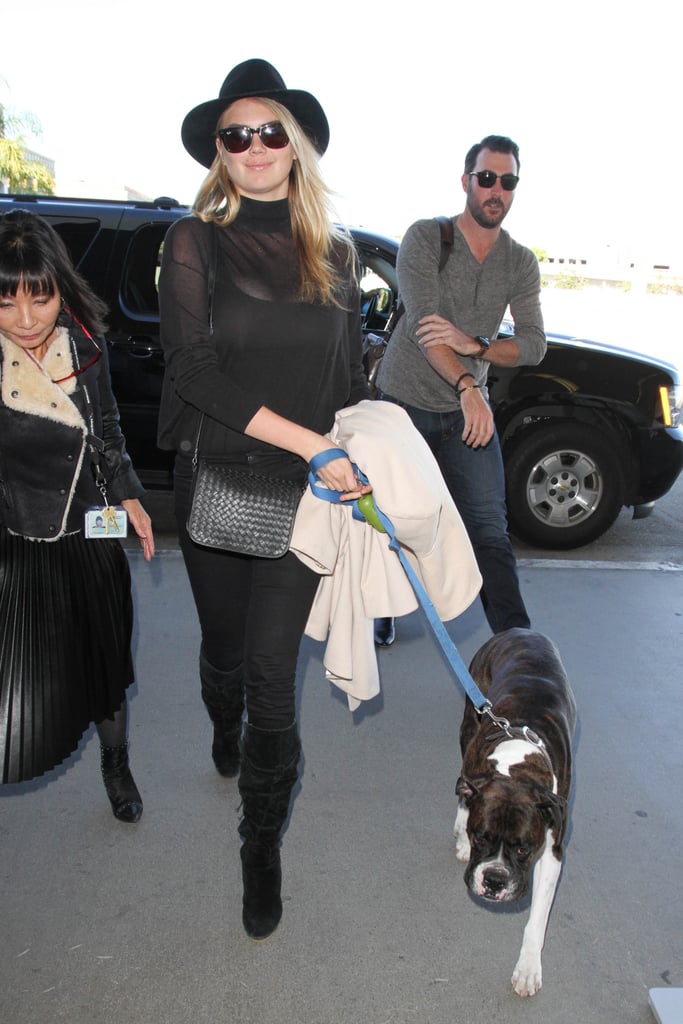 She finished her outfit with luxe matching accessories: a leather woven Bottega Veneta bag and knee-high suede boots.
