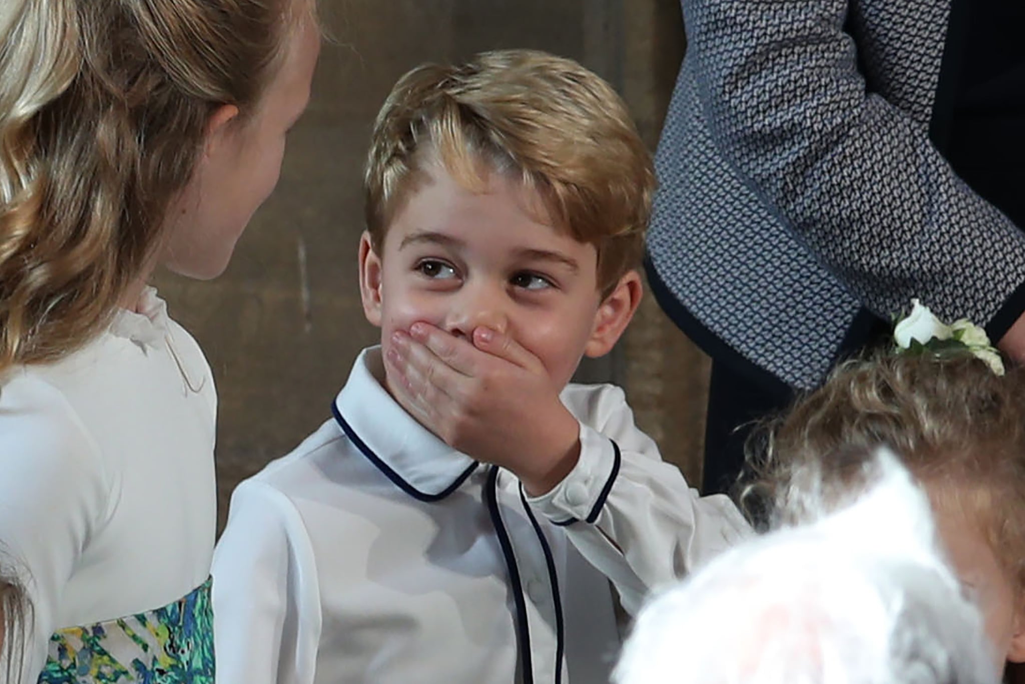 Britain's Prince George of Cambridge reacts as he arrives with other brisdemaids to attend the wedding of Britain's Princess Eugenie of York to Jack Brooksbank at St George's Chapel, Windsor Castle, in Windsor, on October 12, 2018. (Photo by Yui Mok / POOL / AFP)        (Photo credit should read YUI MOK/AFP via Getty Images)