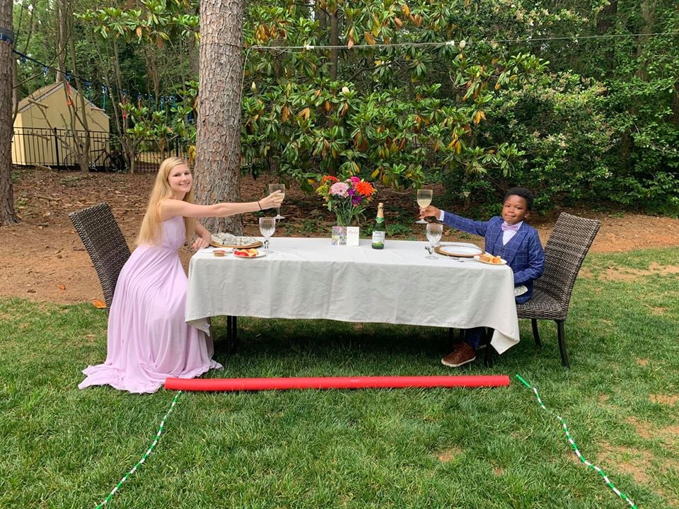 When 17-year-old Rachel Chapman found out Sanderson High School's prom was canceled, she was understandably crushed. Fortunately, Curtis Rogers — the 7-year-old whom she's been nannying for over a year — had a sweet surprise in mind. In the hopes of cheering her up, Curtis planned and staged a mini prom celebration, and the photos will make you smile.
"Tonight Curtis hosted a 'Mini-Prom' for Rachel, our amazing nanny whose Senior Prom was canceled," Elissa, Curtis's mom, captioned a series of Facebook photos showing off her son's work. "He planned almost everything including the promposal, the fancy table to eat at, the 3 course menu, and the playlist of their favorite songs. It wasn't the prom any of us expected but it was an incredible night."
"It wasn't the prom any of us expected but it was an incredible night."
When Rachel saw all the thought Curtis put into his plans, she was extremely moved. "I was very surprised and thought it was so thoughtful!" Rachel told POPSUGAR. "It meant a lot that he picked out all my favorite things and put a lot of effort into it. I'll definitely remember this prom forever."

Ahead, check out photos of the incredible night Curtis planned for Rachel — from the initial promposal to her gorgeous purple dress to the pool noodle they used to properly social distance!

    Related:

            
            
                                    
                            

            These Powerful Graduation Photos Show What the Important Milestone Looks Like in 2020