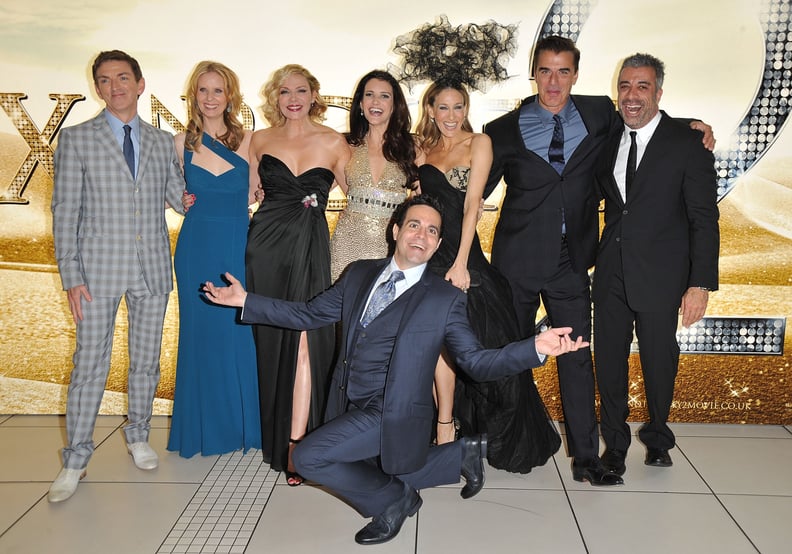 LONDON, ENGLAND - MAY 27:  (L-R) Director Michael Patrick King, Actors Cynthia Nixon, Kim Cattrall, Kristin Davis, Sarah Jessica Parker, Chris Noth, Producer Jon P. Melfi and (front) Actor Mario Cantone attend the UK premiere of Sex And The City 2 at Odeo