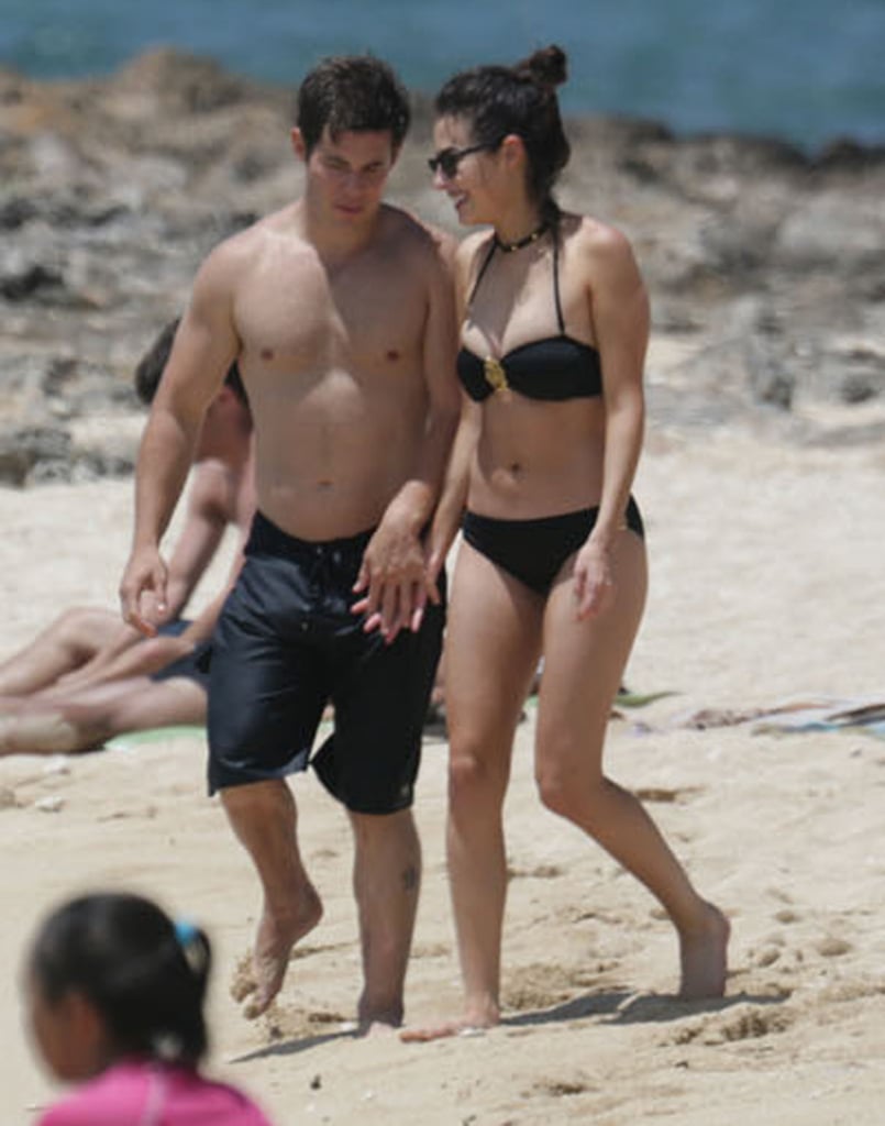 Adam DeVine and his girlfriend, actress Chloe Bridges, held hands as they walked along a beach in Oahu, Hawaii, in May 2015.