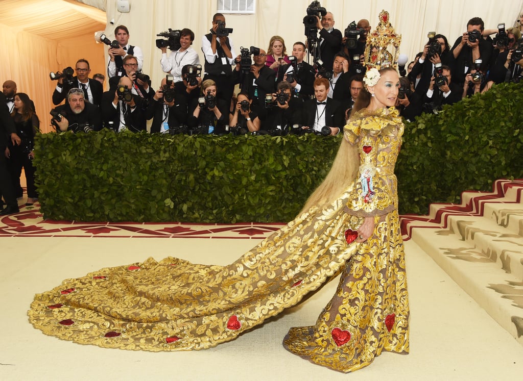 There is no fashion event that Sarah Jessica Parker can't slay, and we were reminded of that fact when she arrived at the 2018 Met Gala on Monday night. Instead of dressing like the Pope, à la Rihanna, the Divorce actress appeared to take inspiration from a cathedral itself for the evening's theme, "Heavenly Bodies: Fashion and the Catholic Imagination." 
She posed in front of photographers at New York's Metropolitan Museum of Art with Andy Cohen on her arm, showing off an elaborate gilded headpiece — which was almost as tall as she is — and matching metallic gown. The train on her dress, which looked about as long as the event's red carpet, is an instant jaw-dropper, so keep reading to see more photos of her look!

    Related:

            
            
                                    
                            

            Sarah Jessica Parker&apos;s Twin Daughters Join Their Stylish Mom For a Fun Night at the Ballet
