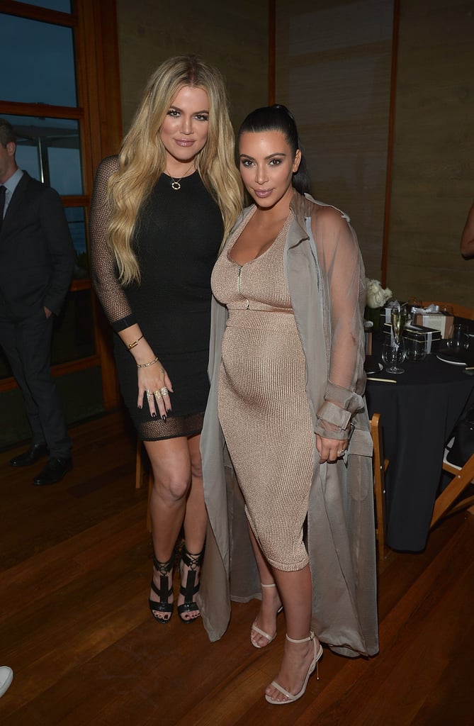 Posing with her sister Khloé Kardashian, Kim opted for a somewhat daring ensemble, layering a sheer duster over a shiny ribbed dress.
