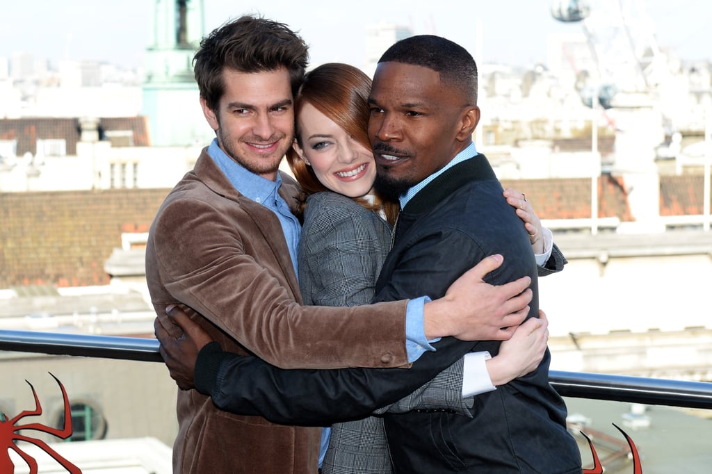 Andrew Garfield and Jamie Foxx gave Emma Stone a hug while promoting The Amazing Spider-Man 2 in London.