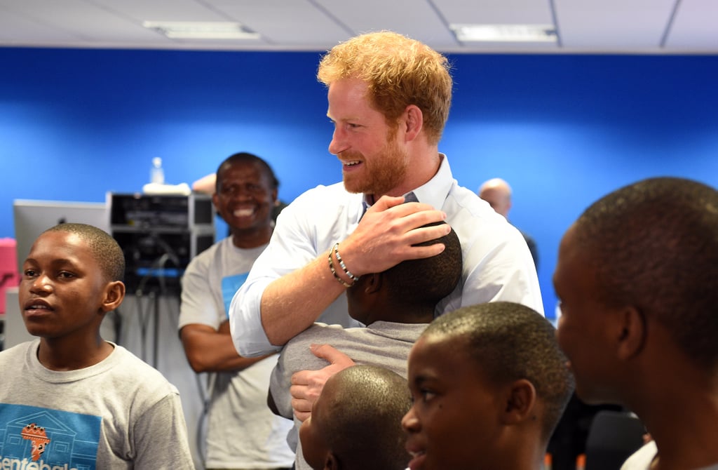 Harry embraced a young student after watching members of the Basotho Youth Choir rehearse in 2016.