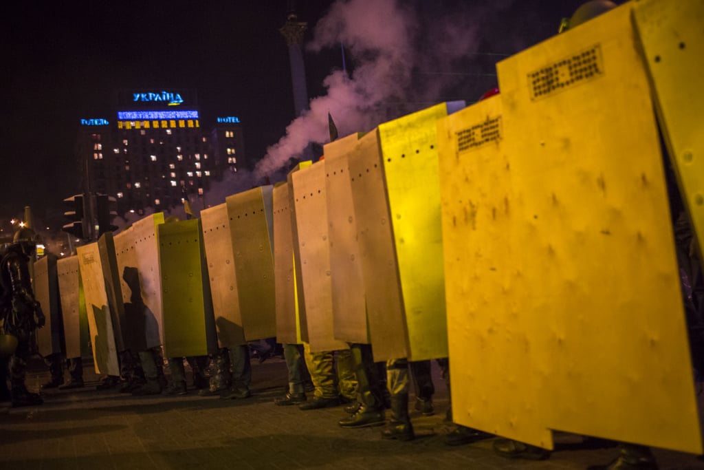 Protesters carried metal shields to march through Kiev.