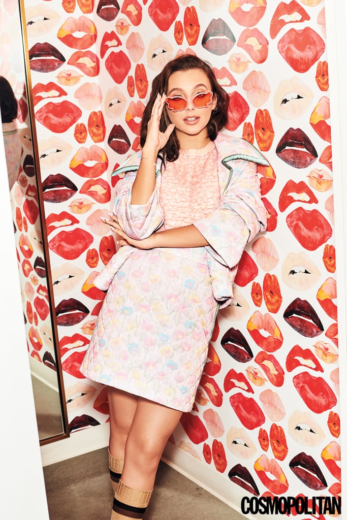 Emma Chamberlain in a quilted floral skirt and jacket set, paired with tinted pink sunglasses.