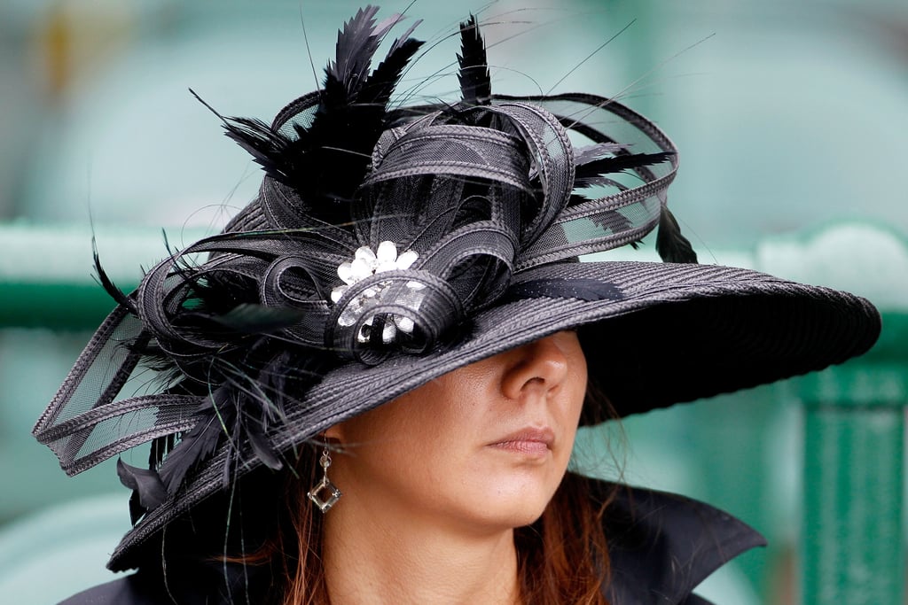 A woman sported a black hat with lots going on in 2010.