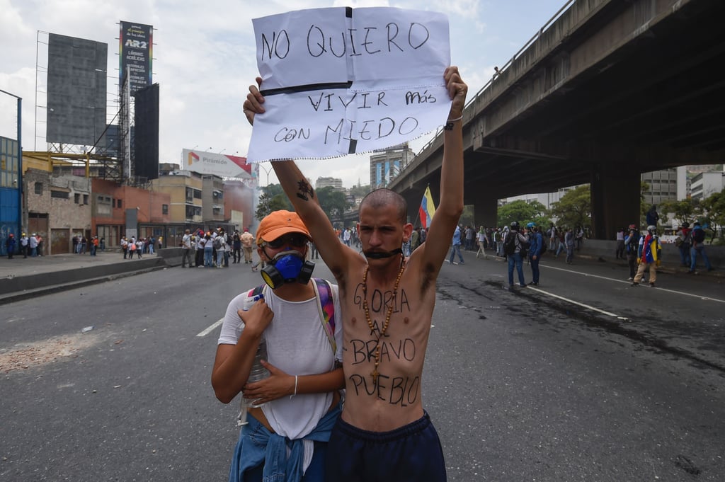 The sign reads "I don't want to live in fear anymore."