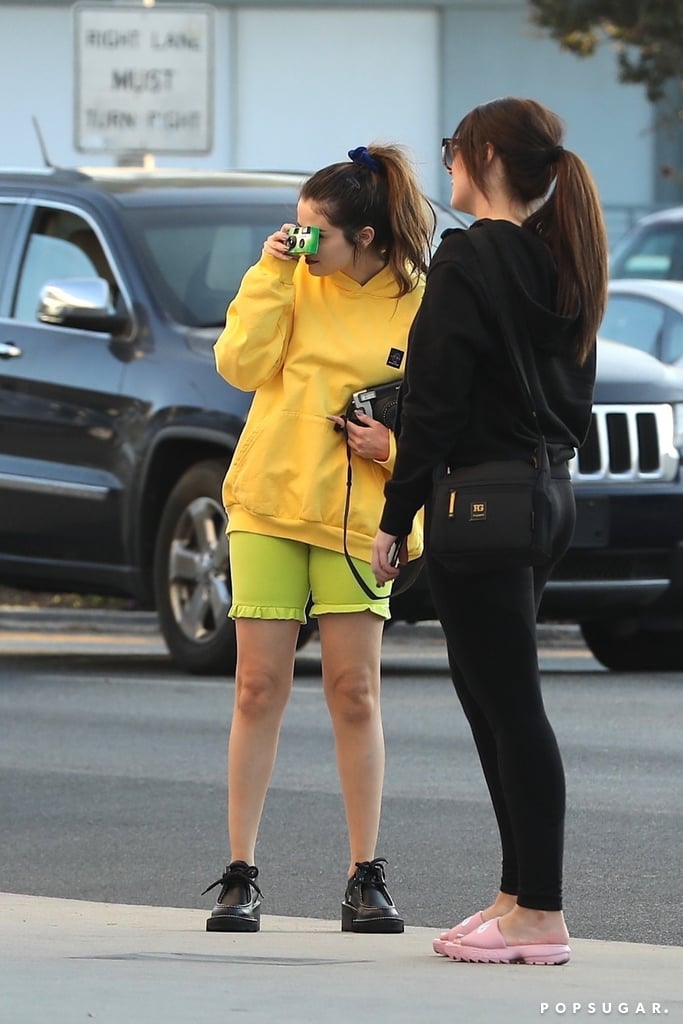 Selena Gomez Wearing a Yellow Hoodie and Lime Biker Shorts in LA