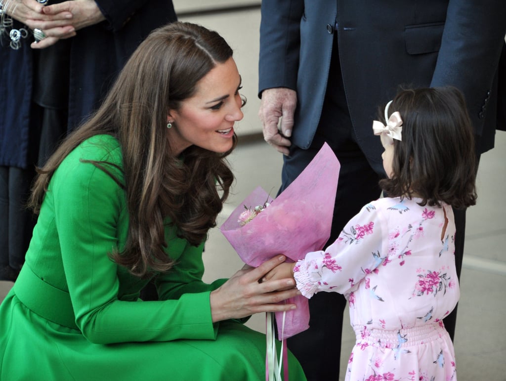 Kate shared a sweet moment with a little girl bearing flowers during a stop on her Australian tour in April 2014.
