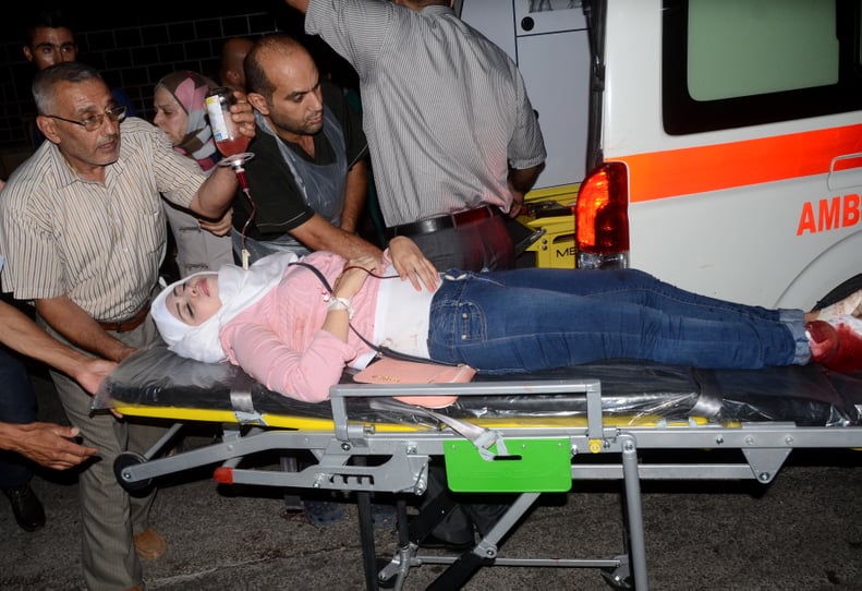 After shelling in the government-held side of Aleppo, an injured woman is rushed to the hospital.