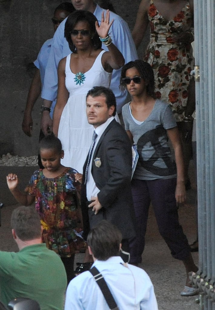 During a July 2009 trip, First Lady Michelle Obama waved after touring the Colosseum with Sasha and Malia.