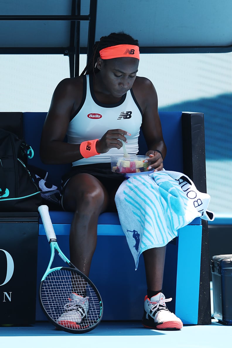 MELBOURNE, AUSTRALIA - JANUARY 22: Coco Gauff of the United States eats fruit salad at a change of ends during the fourth round singles match against Jelena Ostapenko of Latvia during day seven of the 2023 Australian Open at Melbourne Park on January 22, 