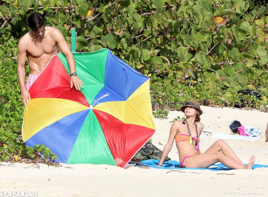 Olivia Palermo's boyfriend, Johanne Huebl, tried to fix their broken beach umbrella while they vacationed together in St. Barts in January 2013.