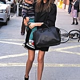 This is how to perfectly pull off an all-black look. Miranda varied the textures of her coat, dress, and Givenchy tote to add visual interest while adding an unexpected pop of blue with a pair of Pierre Hardy sandals — though her best accessory is obviously the adorable Flynn.