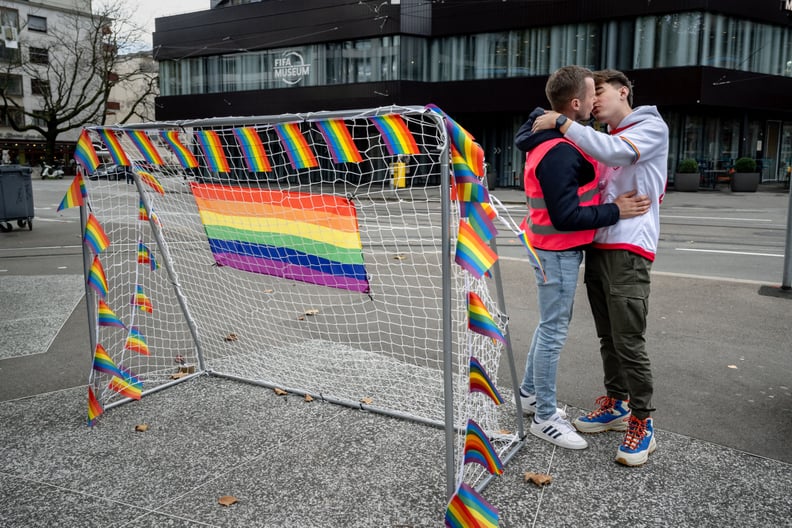 Two men kisses next to a goal during a symbolic action by LGBT+ associations in front of the FIFA museum in Zurich on November 8, 2022, to call FIFA to defend the rights of the LGBT+ community ahead of the Qatar 2022 FIFA World Cup football tournament tha