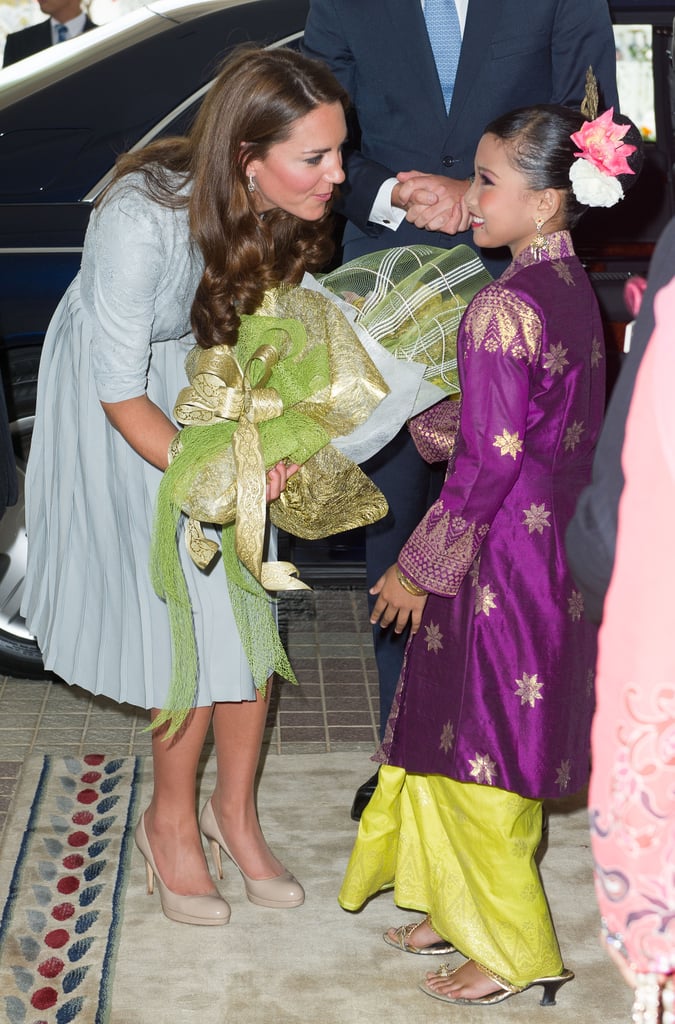 Kate may have been arriving for lunch with the prime minister, but she made time for a sweet greeting with this little girl during her September 2012 stop in Malaysia.