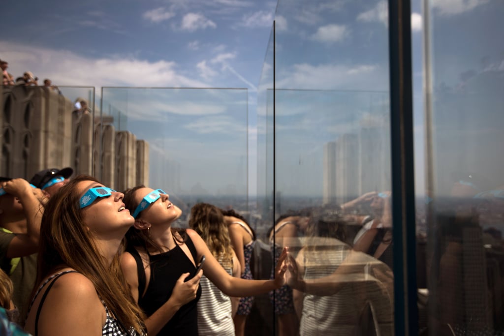 People look up from the Top of the Rock Observatory at Rockefeller Center in New York City.