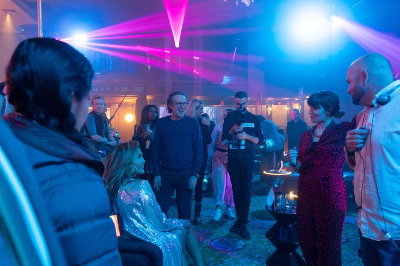 HUSTLERS, seated at left: Jennifer Lopez; at right, in animal print clothing: director Lorene Scafaria, on-set, 2019. ph: Barbara Nitke /  STX Entertainment / courtesy Everett Collection