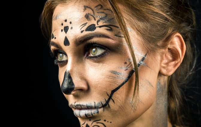 Beautiful woman with halloween make up posing isolated on black background. Close up, copy space.; Shutterstock ID 1208058904; Job: -