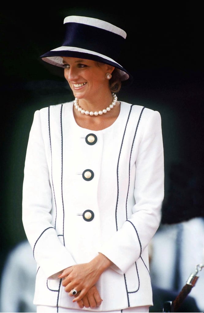 The queen of power suits, Diana chose the same sophisticated, monochrome color palette while attending VJ Day 50th Commemorative Events in 1995. Her black-and-white Tomasz Starsweski suit was coordinated with a Philip Somerville Milliner hat, accompanied by a pearl necklace and earrings.