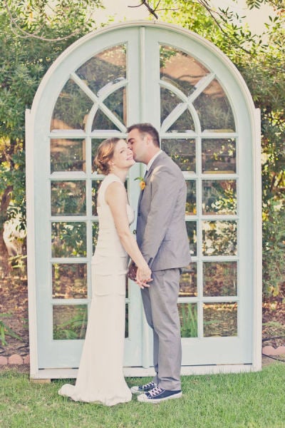 A pair of standing doors perfectly sets the ceremony scene, and the type of doors can make a major statement. Arched glass doors say something very different than antique wooden doors, for instance, so get creative with your options.
Photo by One Love Photography via Style Me Pretty