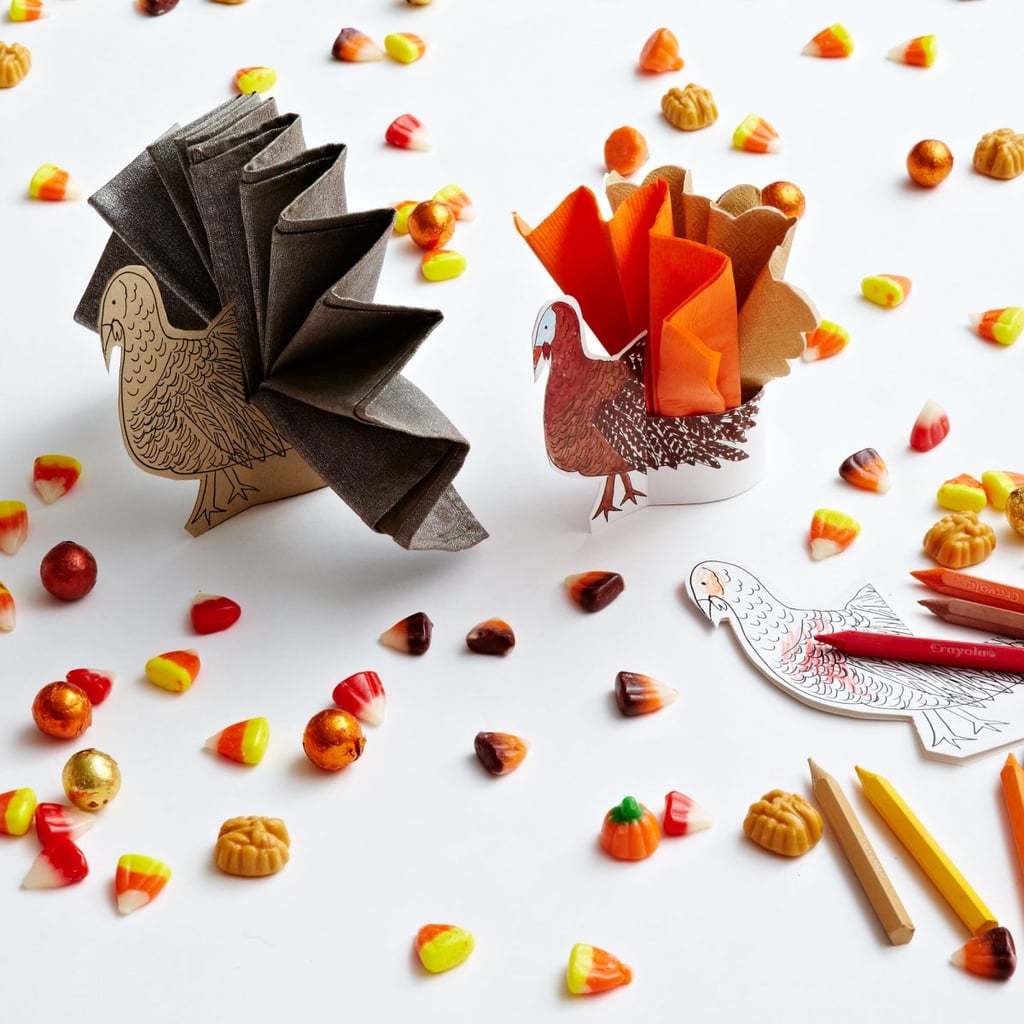 1. Talk turkey with napkin holders. "Since they've already got crayons handy, print out these turkey napkin holders made with my clip art. Once the kids have colored in their turkeys, making the turkey's tail is easy: just fold paper napkins into accordion shapes and get gobbling. Fun project to make ahead of time too — while you cook the Turkey, kids can make their own 'turkey.'"
2. Make Thanksgiving graffiti. "Lay down brown kraft paper as your tablecloth, and you'll open up a world of possibilities. Write messages ahead of time for kids to read when they sit down, or leave fill-in-the-blank sentences like "my favorite part of Thanksgiving is _________." Set out crayons and markers on the table so kids can color, draw, write notes, or even play tic-tac-toe and Thanksgiving hangman. Ask the older kids to write down something they're thankful for — and they can do it right on the table." 
2. Have fun with place cards. "All you need is a square piece of paper and some tape to make cornucopia place cards. Simply roll them paper into a cone and secure shut. Fill it with nuts, dried fruit, and other treats, and set at each place so that kids can dig through before dinner is served. Personalize each one with kids' names (actually, these work great at the adult table, too)."