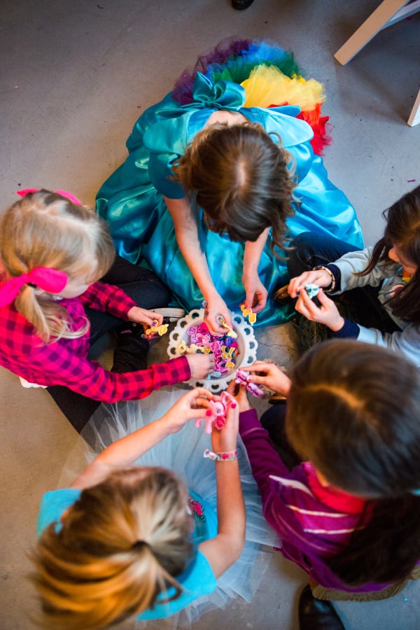 After everyone was sugared up, we played a game! In my effort to incorporate Ally’s My Little Pony toys, we pulled out her My Little Pony Pops and dreamed up a game. Pony Pops are these ponies that come separated and you build them. Their bodies, wings, tails, horns etc come in pieces and the child puts them together.
I separated all the pony pops into two bowls, divided the girls into two groups and told them the object of the game was to build all of the ponies correctly, the fastest. The girls giggled and worked excitedly as a team putting their ponies together.
