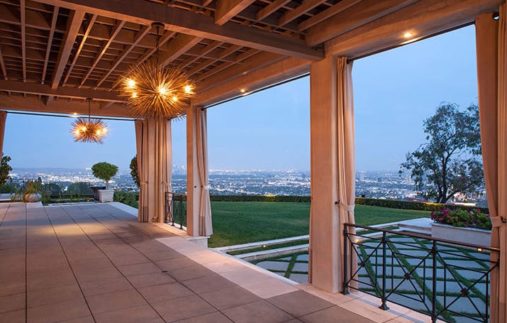The grassy lawn is conveniently located right next to the pool.