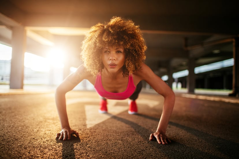 Close up of a young woman doing push ups