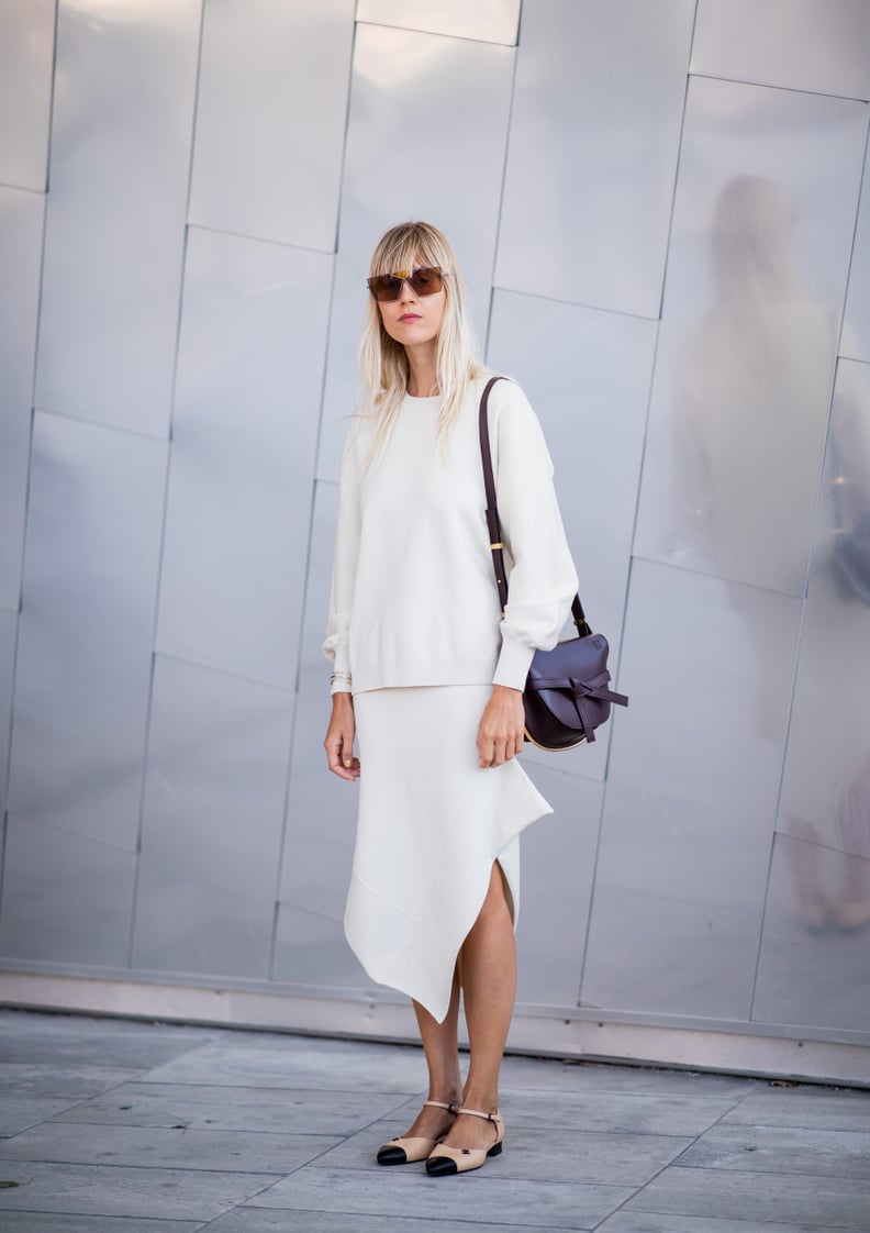 Add Interest to an All-White Look With an Asymmetrical Hem