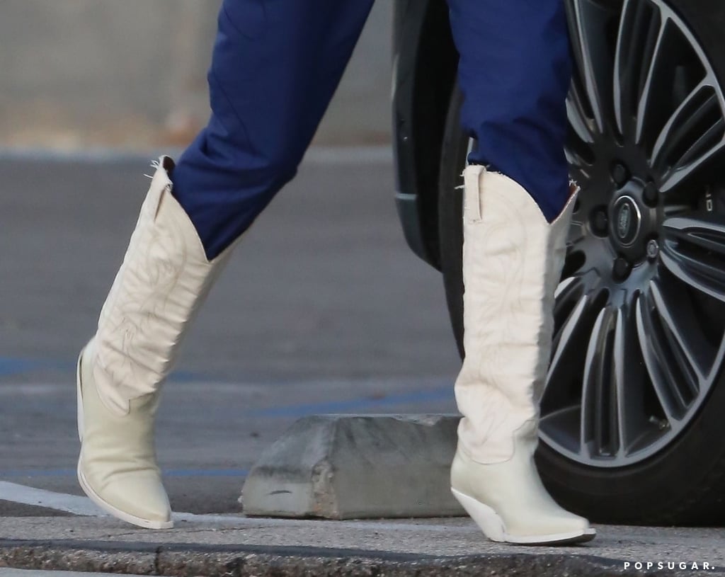 Kendall Jenner White Cowboy Boots and Adidas Track Pants