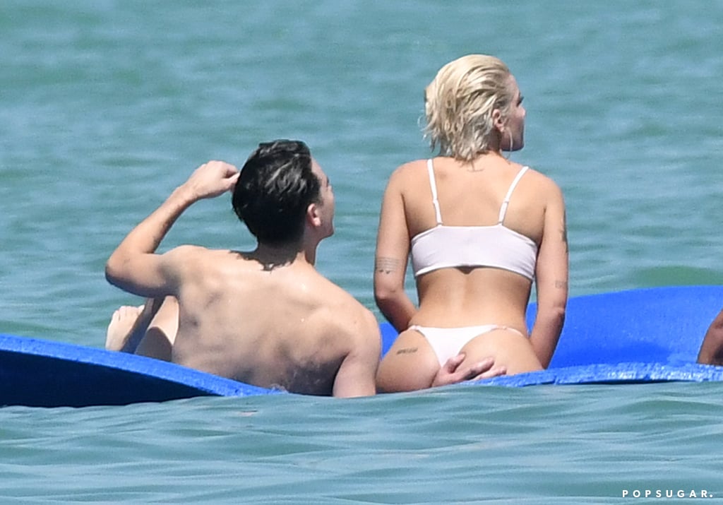 G-Eazy kept his hand on Halsey's backside as they lounged in the water in Miami in March 2018.