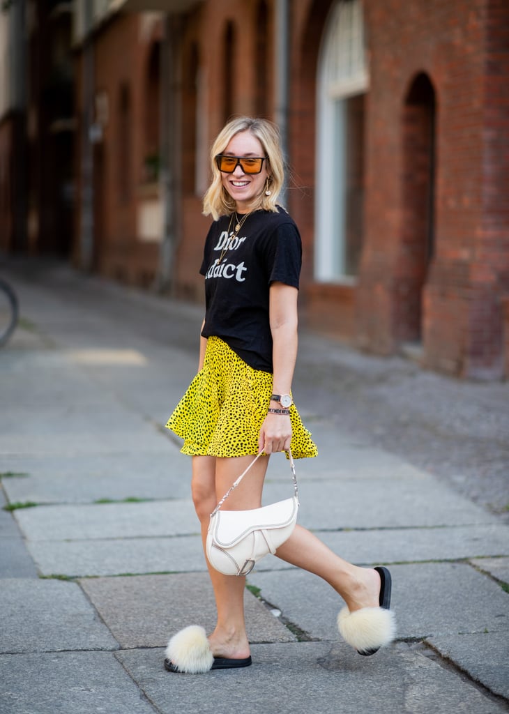 Go quirky-chic and style a printed miniskirt with a graphic tee and fuzzy slides.