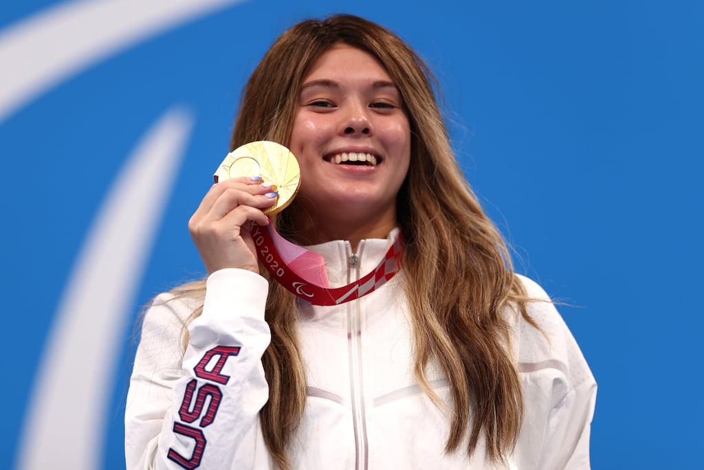 Visually impaired swimmer Gia Pergolini, 17, won her very first gold medal during her debut at the Tokyo Paralympics on Thursday, Aug. 26, in the 100m backstroke S13. She beat the world record she set at the Paralympic Trials (1:05.31) — twice! In the video below, witness Pergolini set a new record during the second preliminary heat, with a time of 1:05.05. She then swam with a time of 1:04.64 in the 100m backstroke S13 finals, again setting a new record. 
IN WORLD RECORD FASHION. 17-year-old Gia Pergolini claims the world record and a spot in the 100m backstroke S13 finals. #TokyoParalympics pic.twitter.com/UWgsa5aaQw— Team USA (@TeamUSA) August 26, 2021


Who Is Gia Pergolini?
Pergolini started swimming when she was 4 years old and started competing when she was 5. She began losing her vision as a child, and by age 10 in 2014, she was diagnosed with Stargardt disease. This is an inherited disorder that affects the retina, the part of the eye that senses light.
The S13 classification is for visually impaired people who have slightly more visibility than those in the S12 or S11 categories. Pergolini shared with Team USA, "I can still see the flags and the wall, so that's a good advantage that I have, and I'm very grateful for that."
Pergolini didn't let her diagnosis stop her from swimming and began para swimming when she was 12 years old. Now, she has a gold medal to show for all her hard work and determination! Keep reading to see all the proud photos of her winning gold.

    Related:

            
            
                                    
                            

            Blind Swimmer Anatasia Pagonis Wins USA&apos;s First Gold Medal at Tokyo Paralympics and Breaks World Record