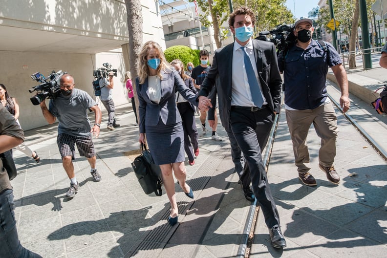 Elizabeth Holmes (C), founder and former CEO of blood testing and life sciences company Theranos, leaves the courthouse with her husband Billy Evans after the first day of her fraud trial in San Jose, California on September 8, 2021. - California jurors t
