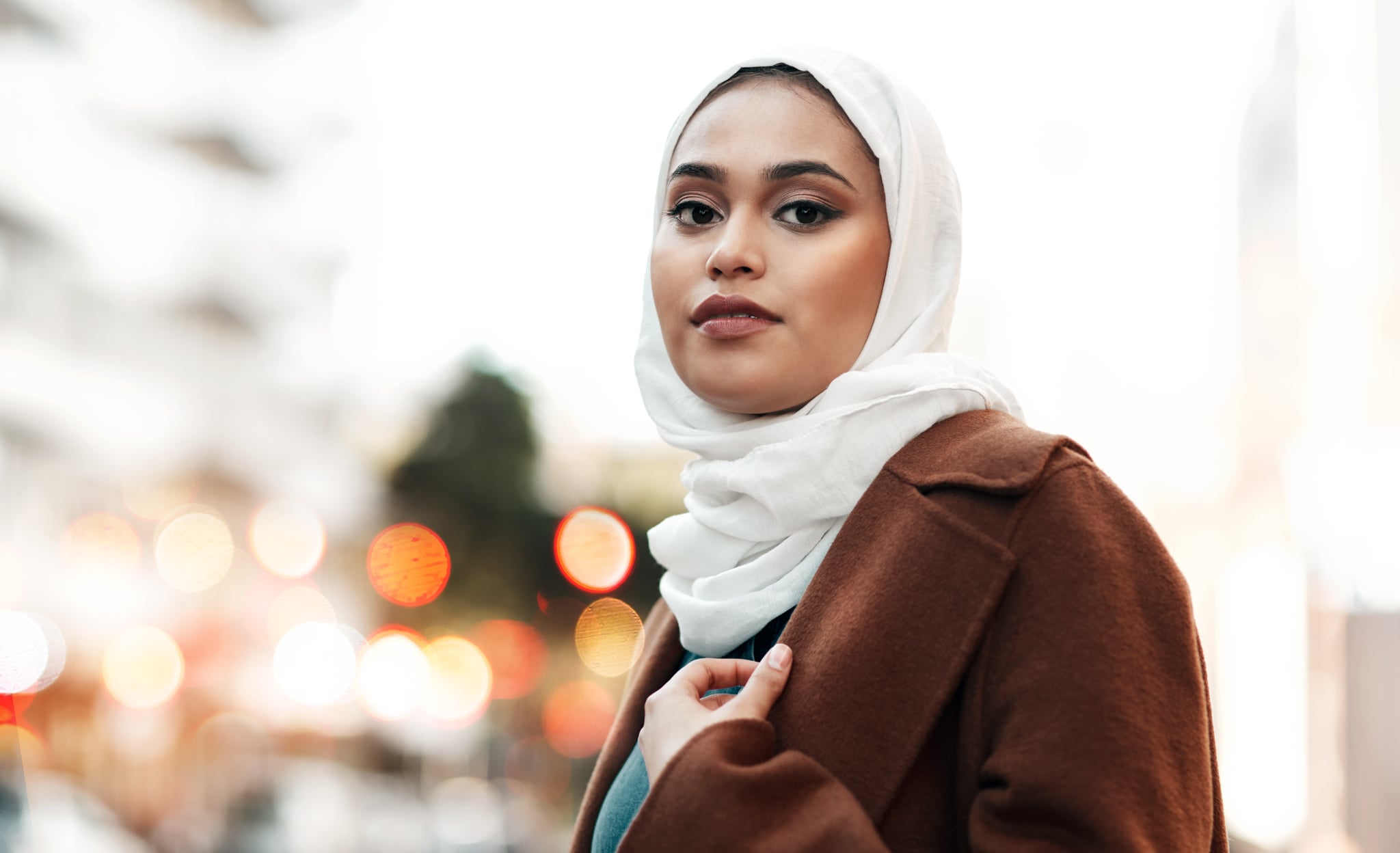 sshot of a woman wearing a hijab and standing alone to illustrate high-functioning anxiety