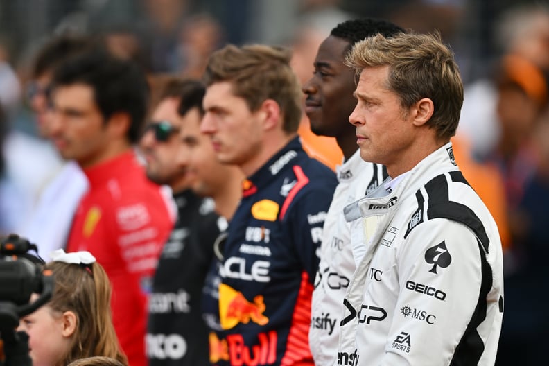 NORTHAMPTON, ENGLAND - JULY 09: Brad Pitt, star of the upcoming Formula One based movie, Apex, and Damson Idris, co-star of the upcoming Formula One based movie, Apex, stand for thr national anthem on the grid during the F1 Grand Prix of Great Britain at 