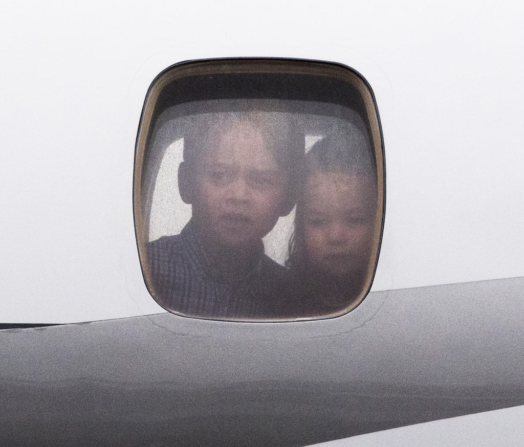 George and Charlotte Looking Out of Plane Windows Pictures