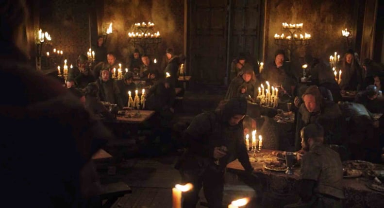 Two rows of candlelit banquet tables at the Red Wedding Revenge