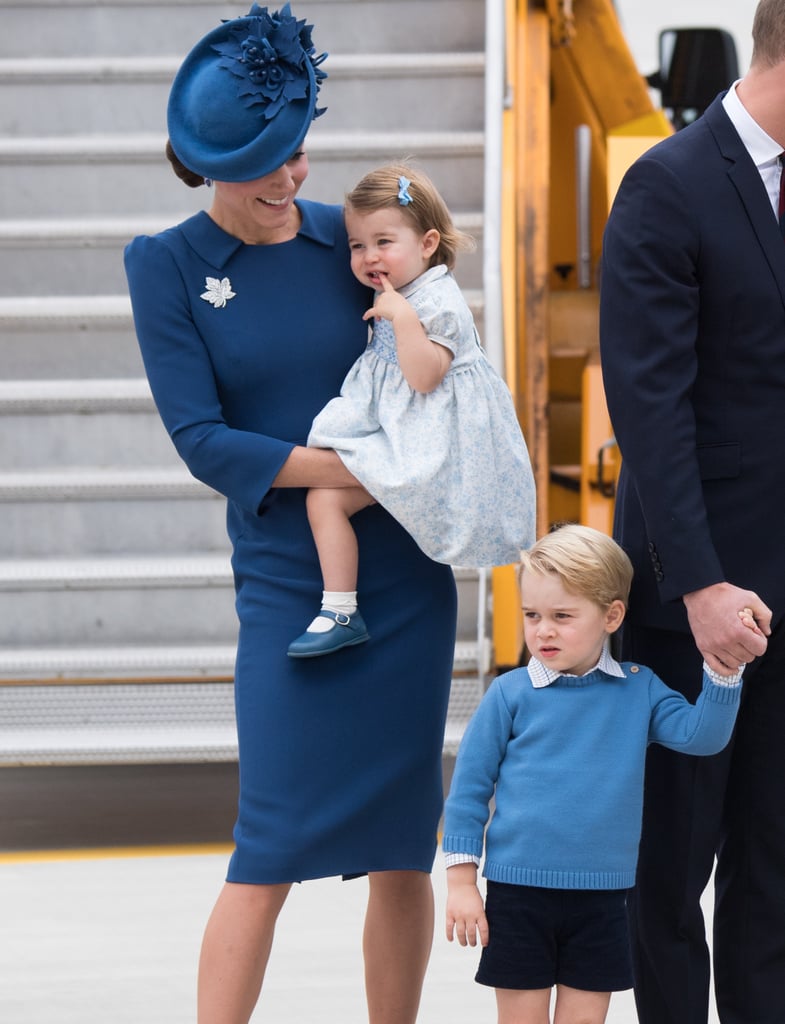 Even though Kate was holding Charlotte, she couldn't help but smile at George.