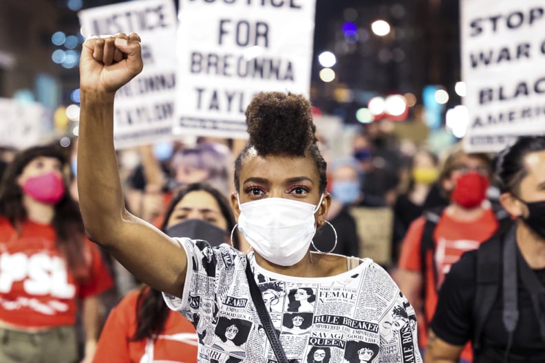 DENVER, CO - SEPTEMBER 23: Sheree Barbour holds her fist in the air as people protest the grand jury decision in the Breonna Taylor case on September 23, 2020 in Denver, United States. The death of Taylor, who was shot and killed by officers executing a s