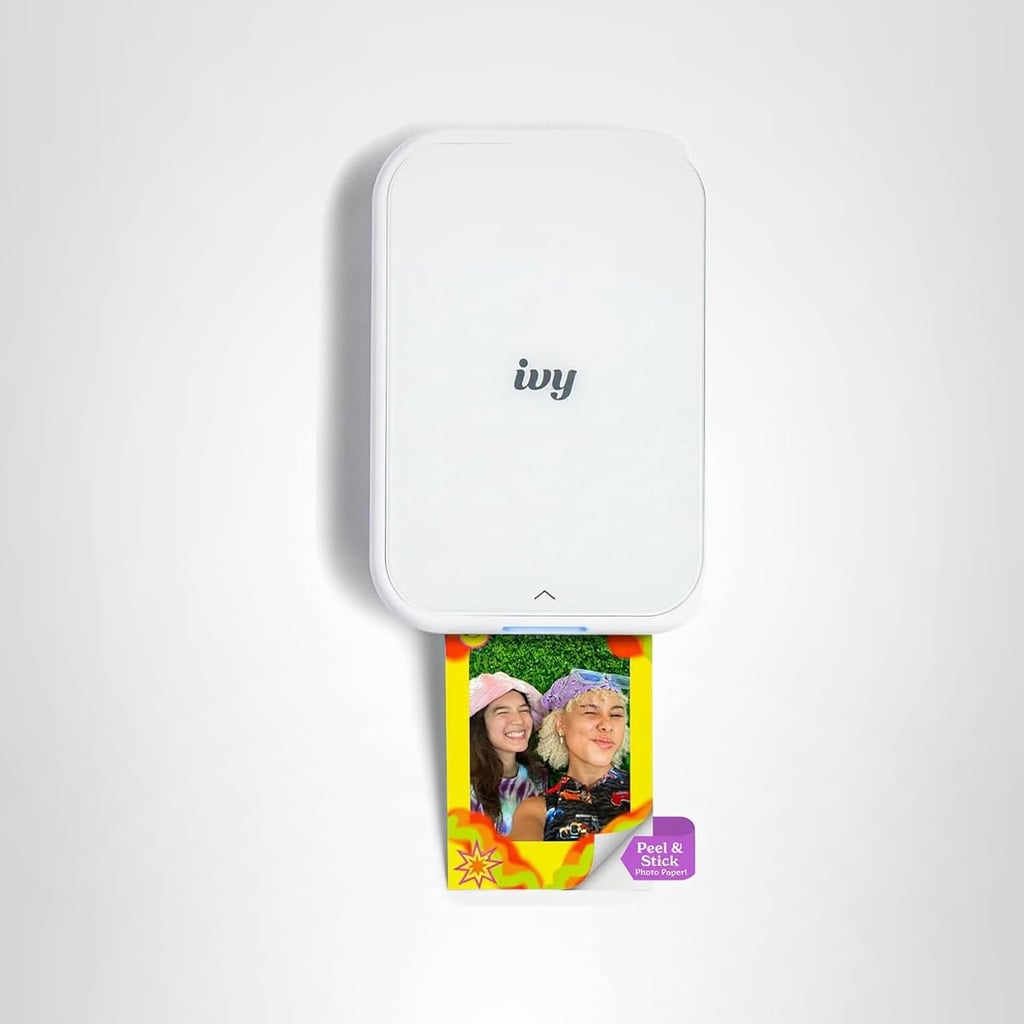 Canon Ivy 2 Mini Photo Printer ($100, originally $120)
This little photo printer turns the thousands of photos in your camera roll into tangible prints in seconds. Interestingly, it doesn't need ink at all, which still confuses me, TBH). Instead, it uses colorful dye-based crystals embedded in the paper. You can add cute designs or borders before printing, and each photo has a peel-and-stick backing if you want to display them somewhere.